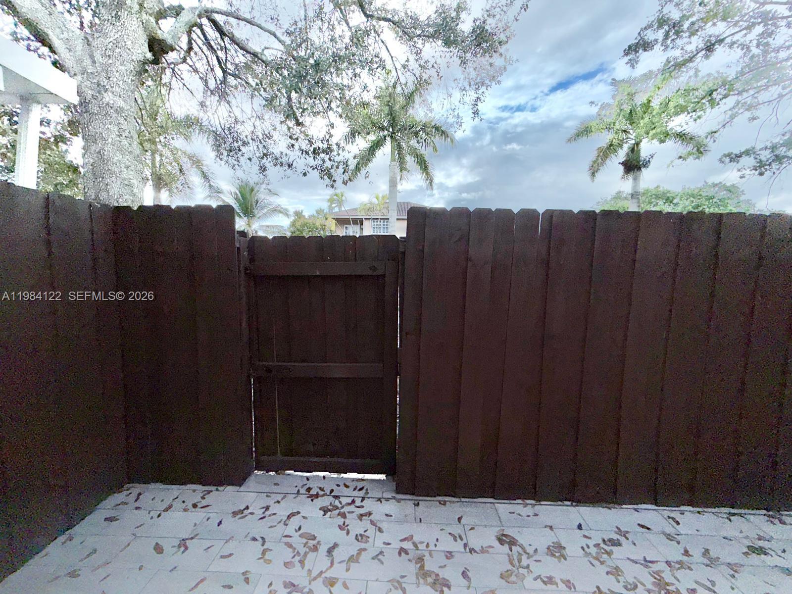 3858 Southwest 153rd Place Miami, FL 33185 - Photo 30 of 37 a wooden door with a wooden fence