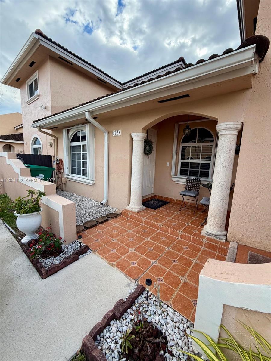 3858 Southwest 153rd Place Miami, FL 33185 - Photo 5 of 37 a front view of a house with a yard