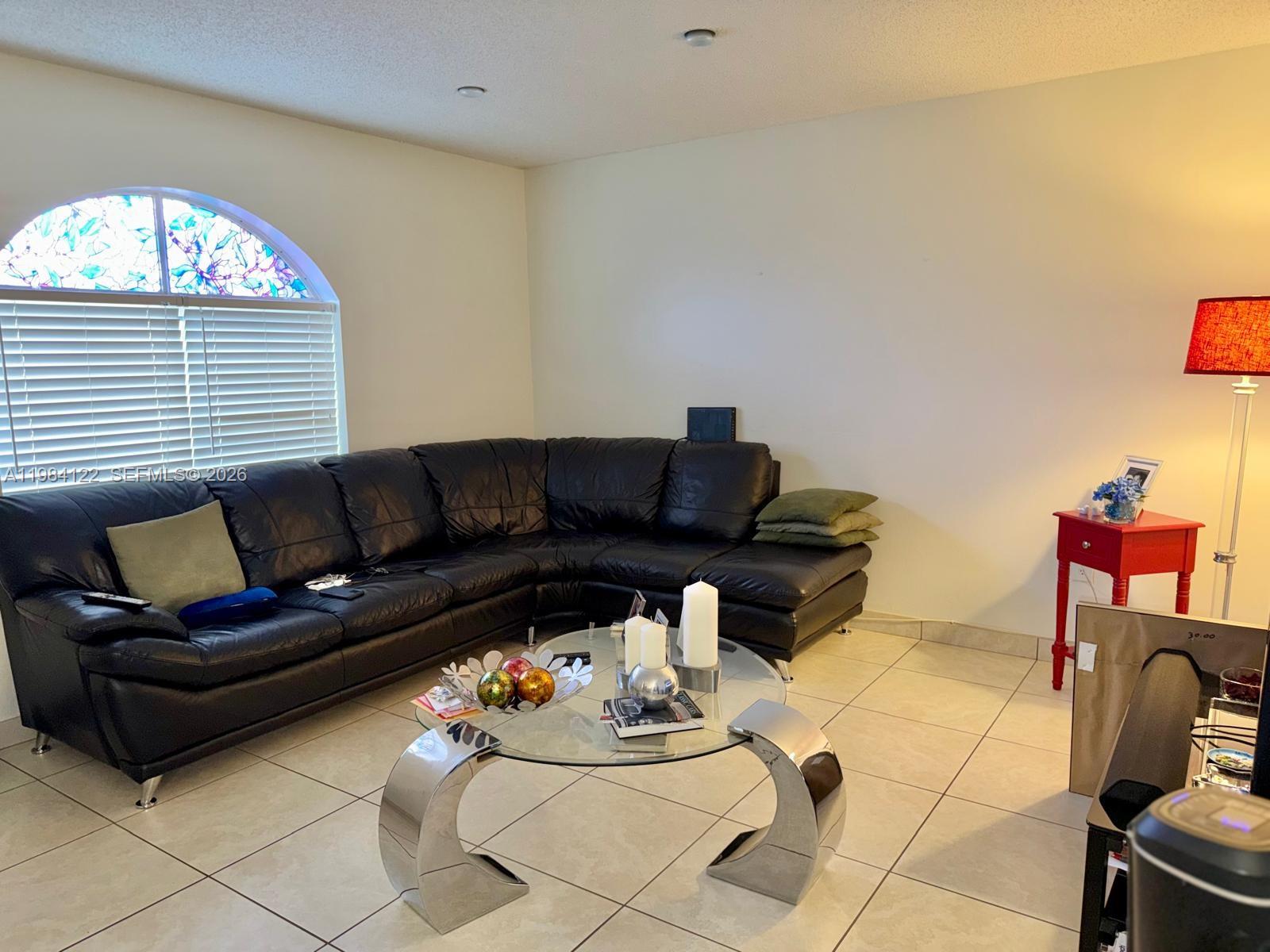 3858 Southwest 153rd Place Miami, FL 33185 - Photo 10 of 37 a living room with furniture a couch and a window