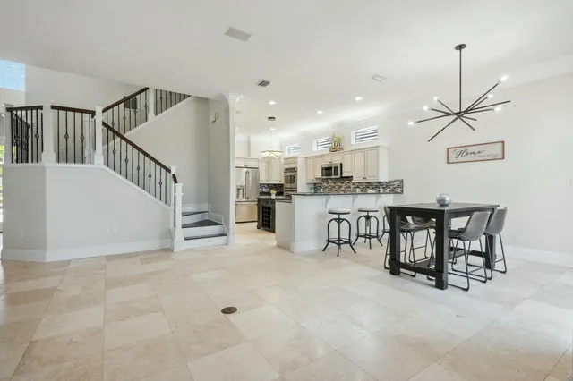 a kitchen with stainless steel appliances granite countertop a stove a sink and a refrigerator