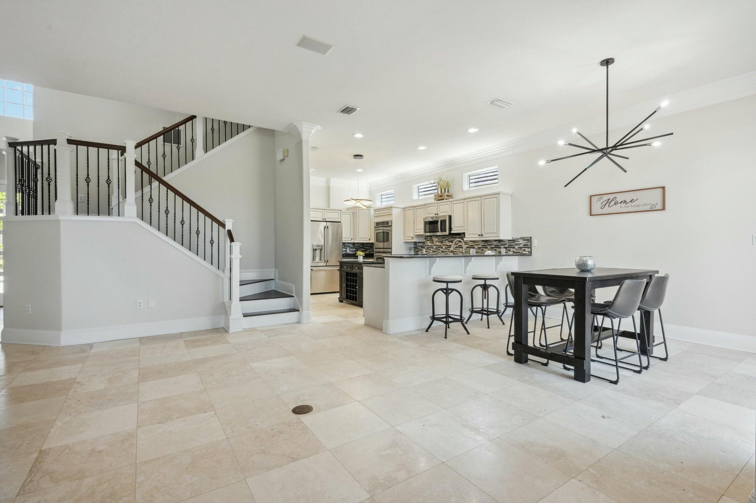 294 Ketch Court Destin, FL 32541 - Photo 13 of 56 a kitchen with stainless steel appliances kitchen island granite countertop a table and chairs in it