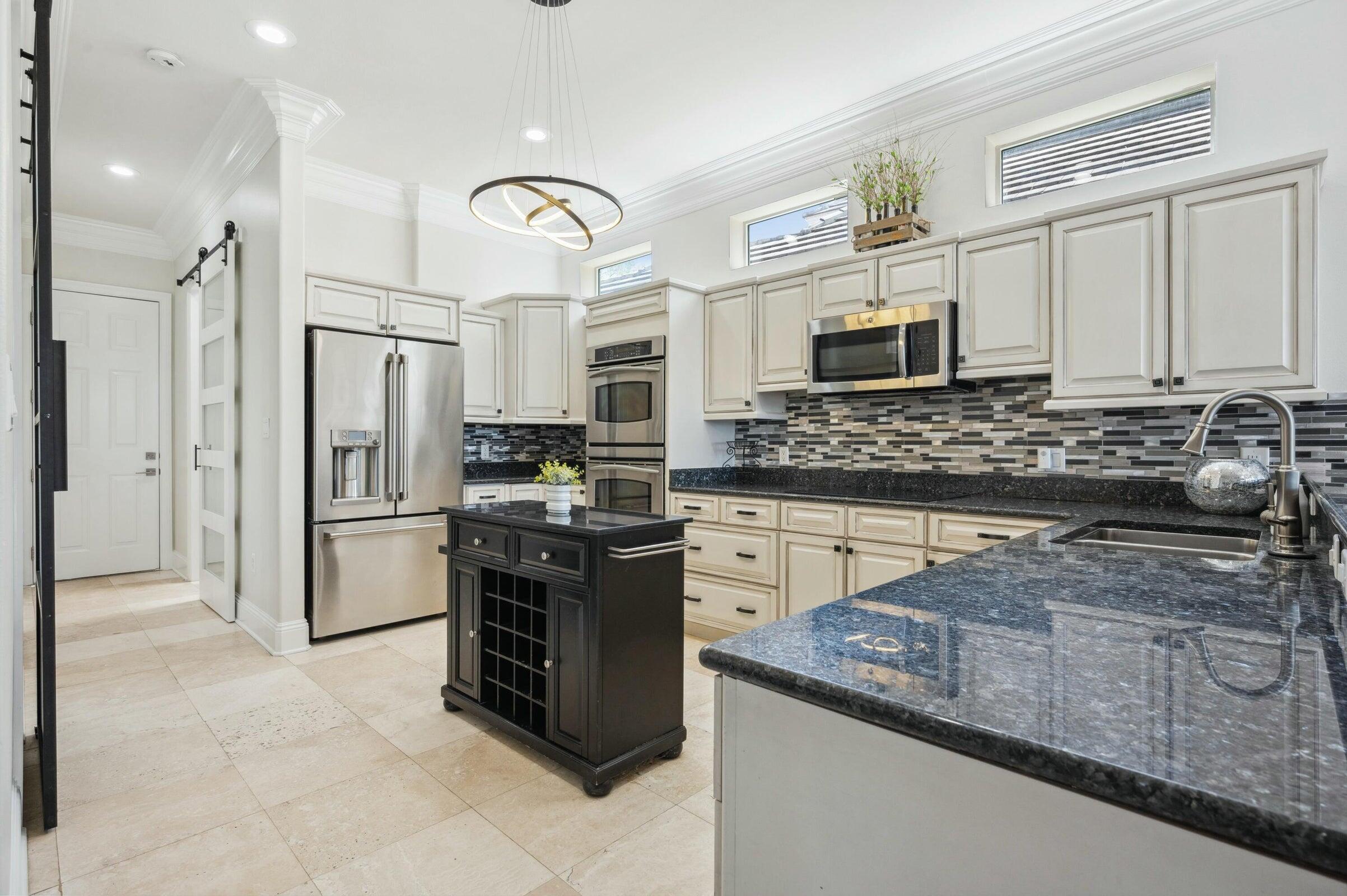 294 Ketch Court Destin, FL 32541 - Photo 15 of 56 a kitchen with stainless steel appliances granite countertop a stove a sink and a refrigerator