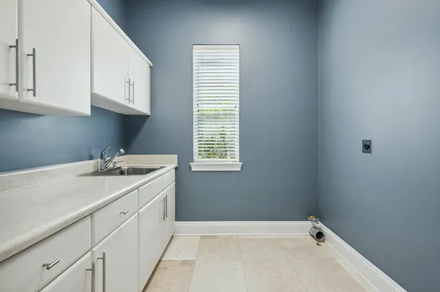 an empty room with a window and a ceiling fan