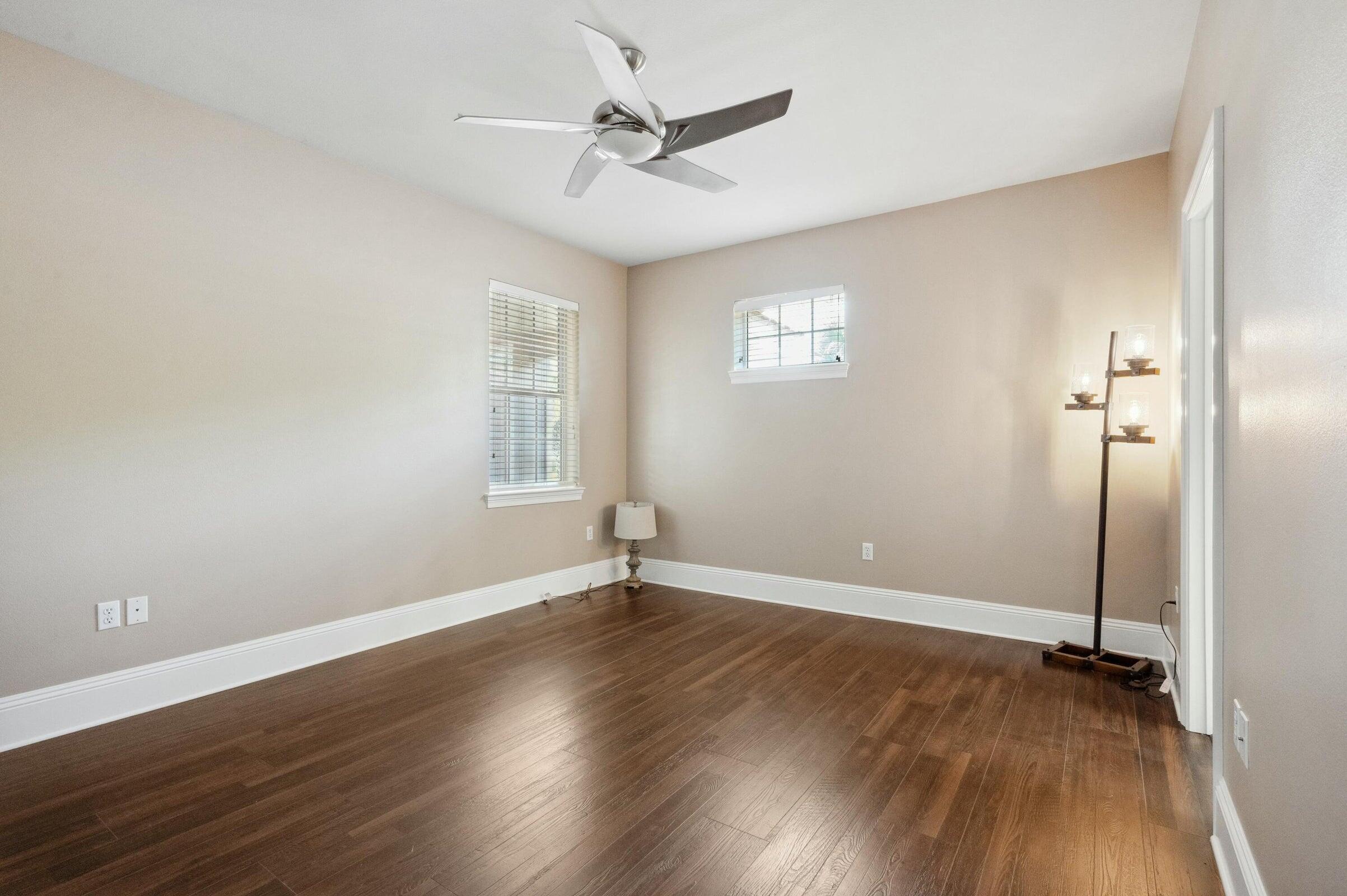 294 Ketch Court Destin, FL 32541 - Photo 30 of 56 an empty room with wooden floor fan and windows