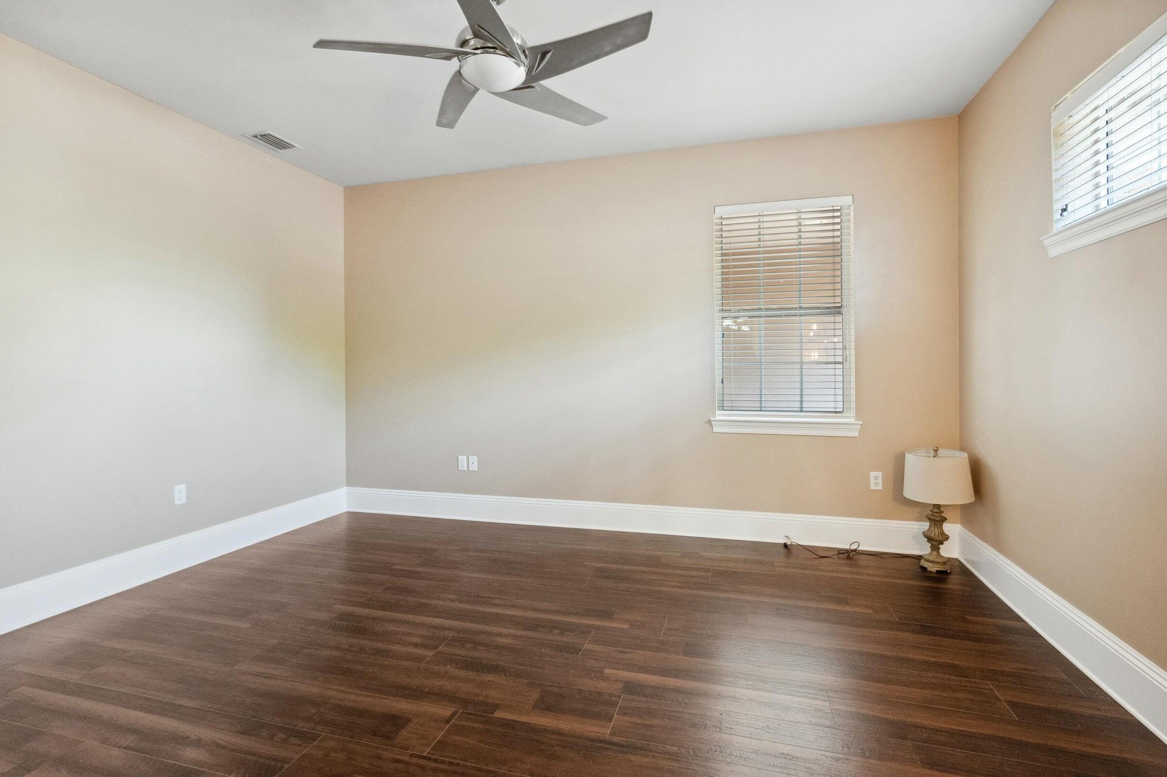 294 Ketch Court Destin, FL 32541 - Photo 31 of 56 an empty room with wooden floor fan and windows