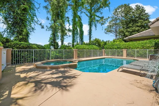 a view of a sign board with flower garden