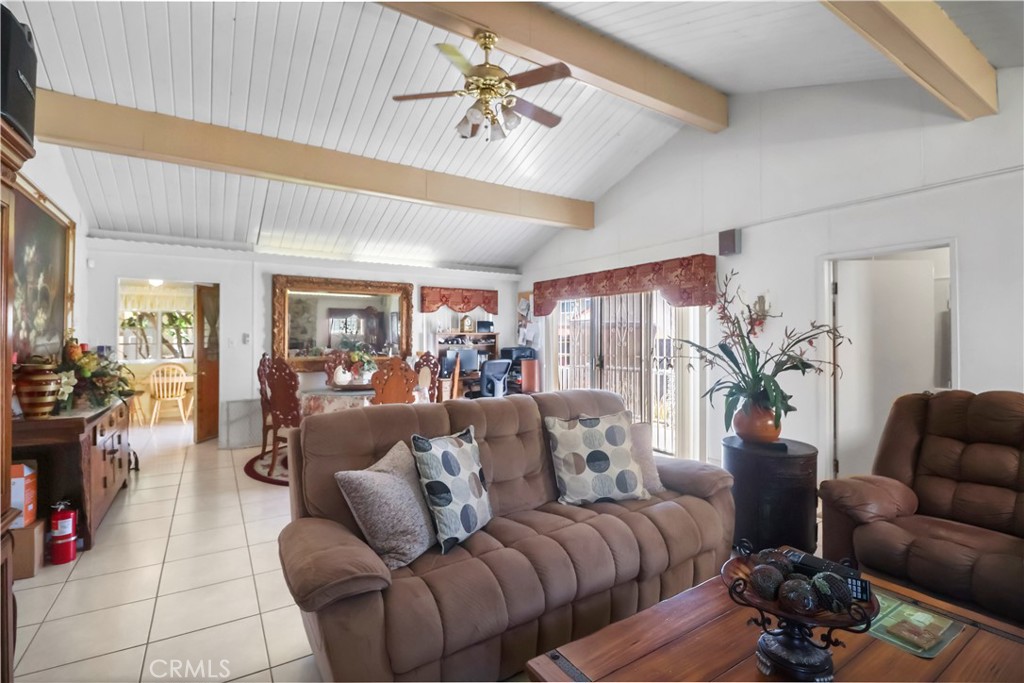 9206 Rendalia Street Bellflower, CA 90706 - Photo 15 of 27 a living room with furniture and a chandelier
