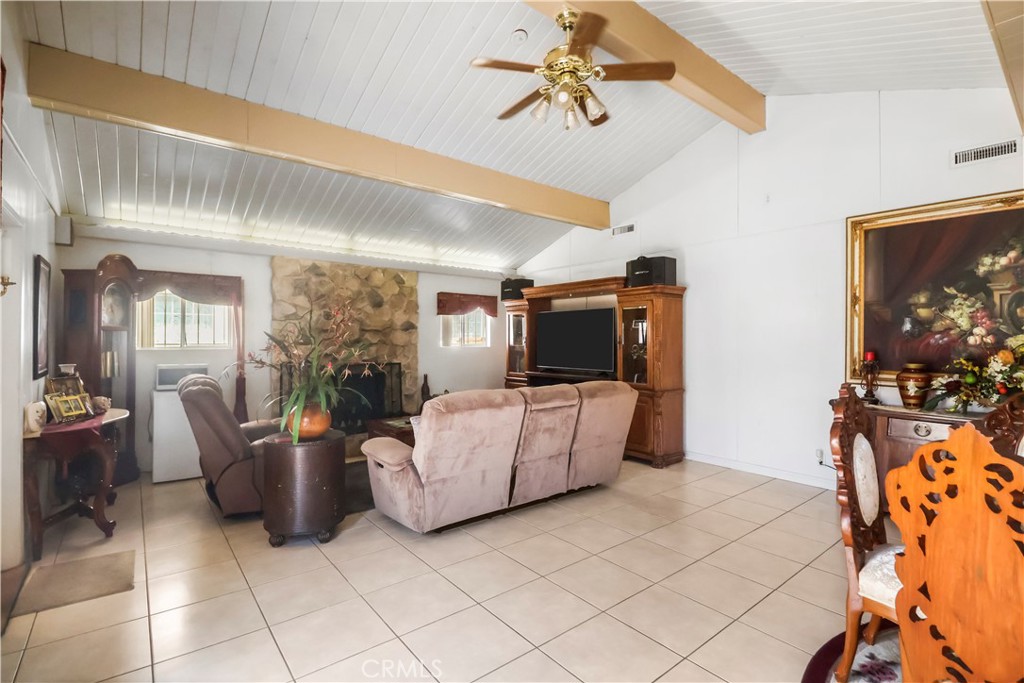 9206 Rendalia Street Bellflower, CA 90706 - Photo 16 of 27 a living room with furniture and a flat screen tv
