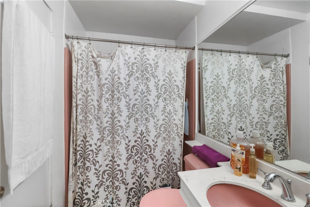 9206 Rendalia Street Bellflower, CA 90706 - Photo 17 of 27 a bathroom with a sink toilet and shower