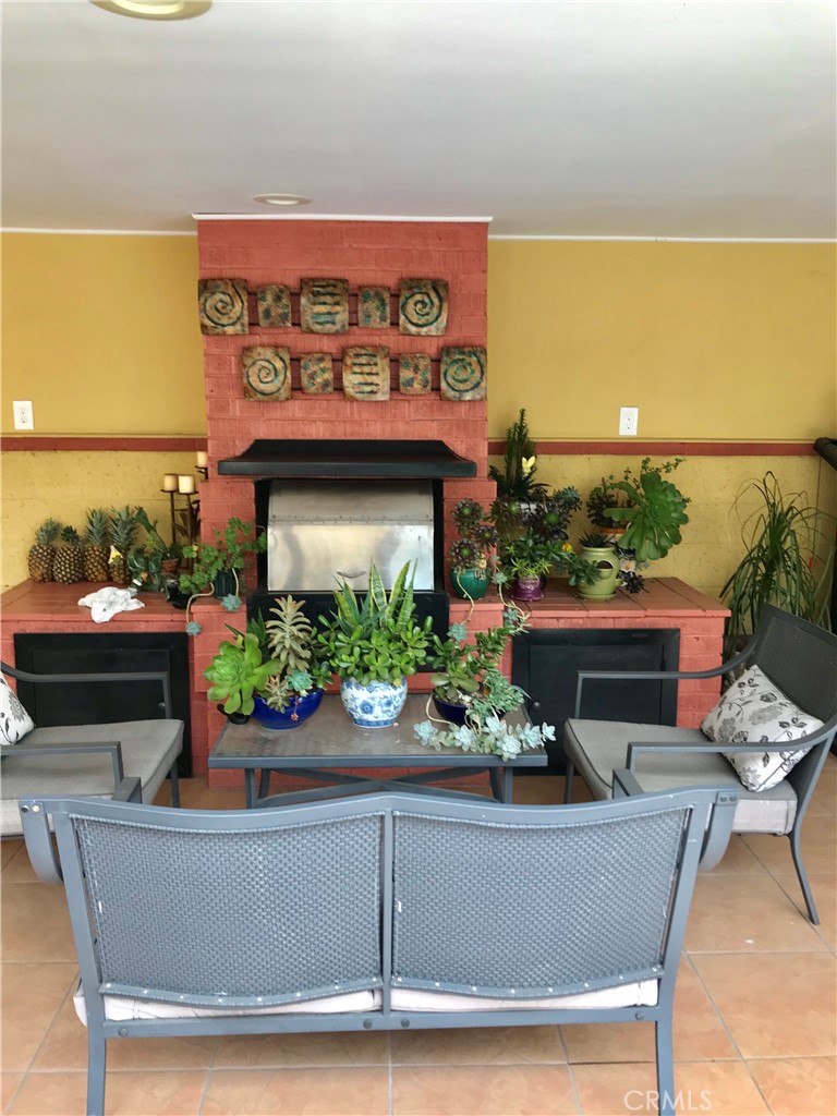 9206 Rendalia Street Bellflower, CA 90706 - Photo 18 of 27 a view of a dining chair with potted plants