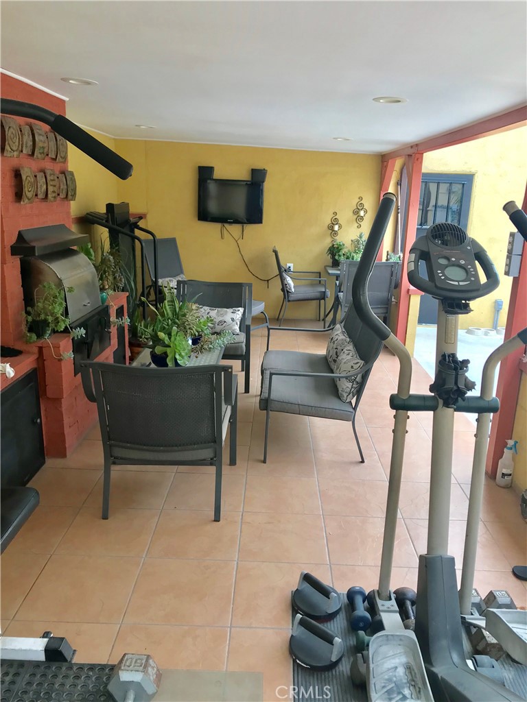 9206 Rendalia Street Bellflower, CA 90706 - Photo 20 of 27 a living room with furniture and floor to ceiling window
