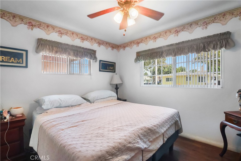 9206 Rendalia Street Bellflower, CA 90706 - Photo 8 of 27 a bedroom with a bed and a chandelier