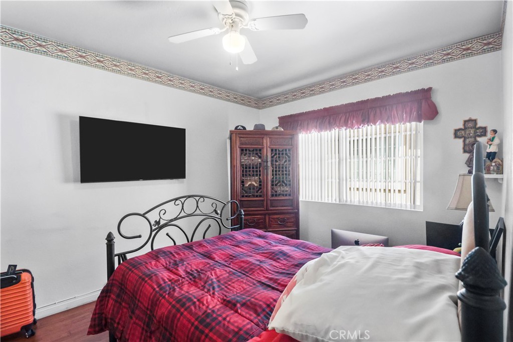 9206 Rendalia Street Bellflower, CA 90706 - Photo 9 of 27 a bedroom with a bed and a flat screen tv