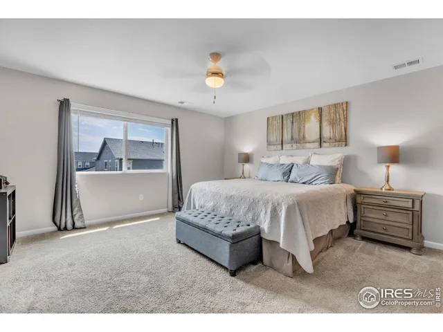 a living room with a bed furniture and a window