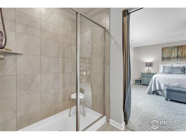 a bedroom with a bed and a glass door