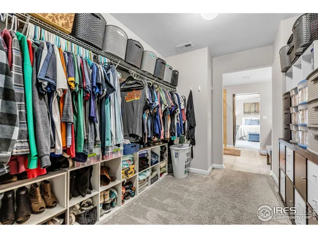 a view of walk in closet with clothes
