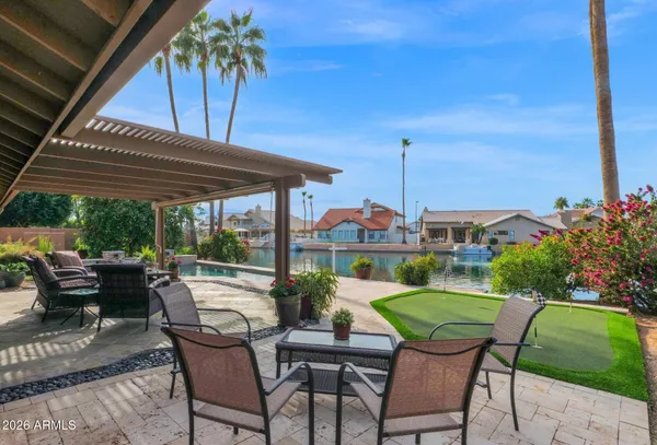 a view of a patio with table and chairs potted plants with wooden fence