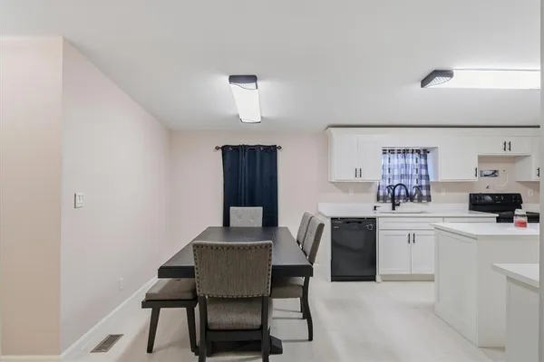 a view of a dining room that has a table and chairs in it
