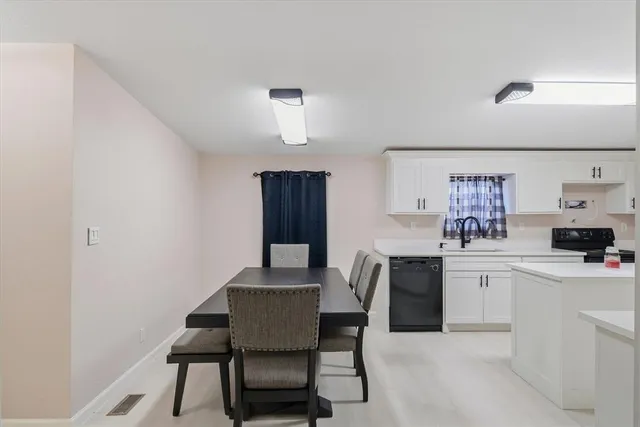 a view of a dining room that has a table and chairs in it