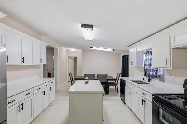 a kitchen with appliances a sink and cabinets