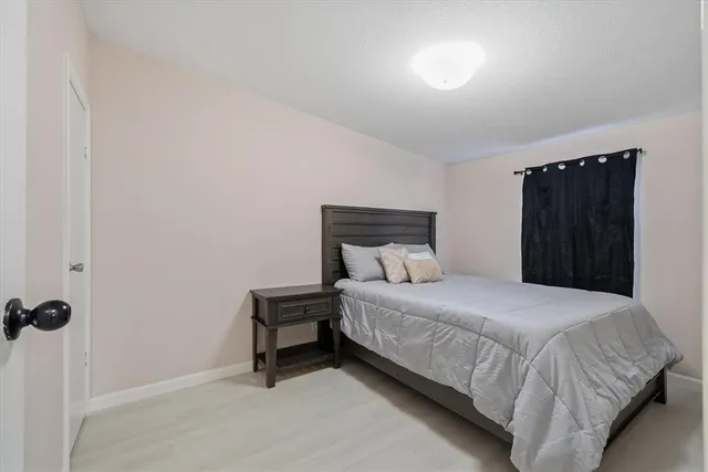 a bedroom with a bed and a dresser