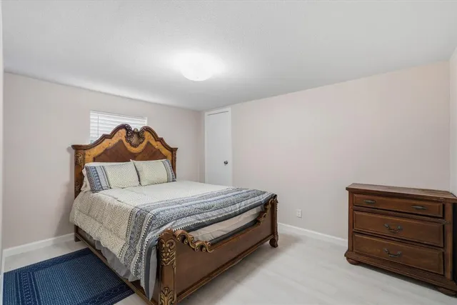 a bedroom with a bed and a dresser