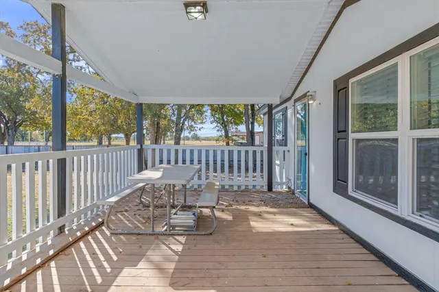 a view of a balcony with wooden floor