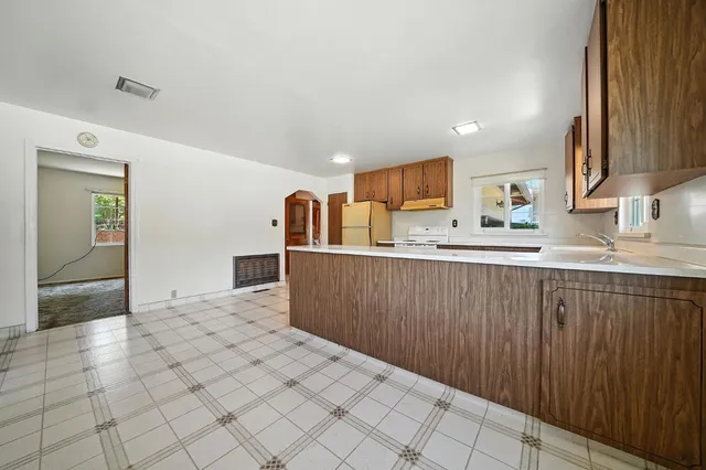a kitchen with stainless steel appliances a sink and cabinets