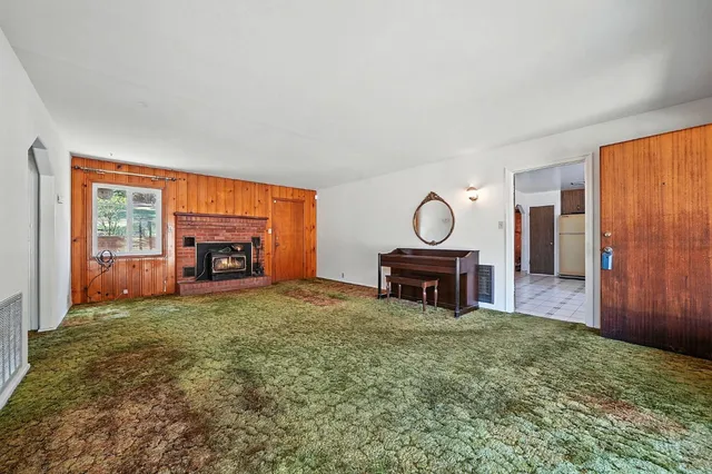 a view of living room with furniture and a fireplace
