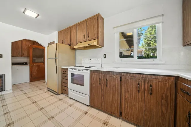 a kitchen with stainless steel appliances a refrigerator sink and cabinets