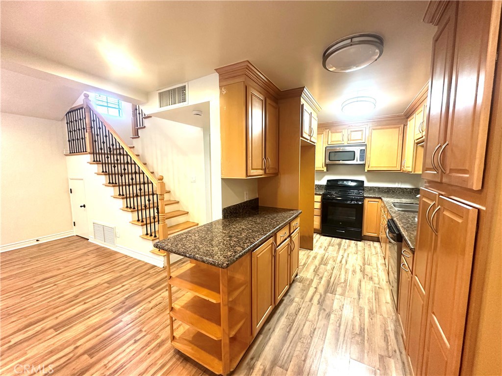 9356 19th Street, Unit A Rancho Cucamonga, CA 91701 - Photo 5 of 23 a kitchen with stainless steel appliances granite countertop a sink stove and refrigerator