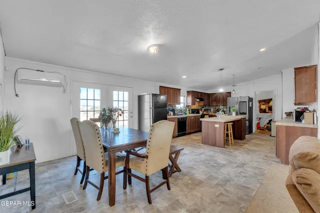 a dining room with furniture and view kitchen