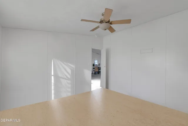 a view of a livingroom with a ceiling fan and wooden floor