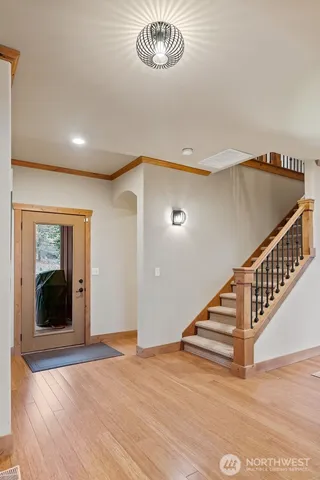 a view of entryway and hall with wooden floor