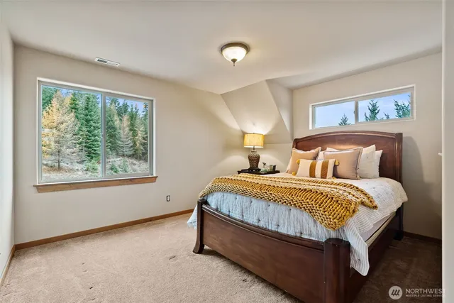 a bed sitting in a bedroom next to a window