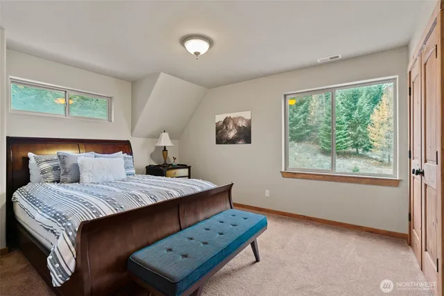 a bedroom with a bed and a lamp next to a window