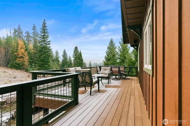 a view of balcony with chairs and wooden fence