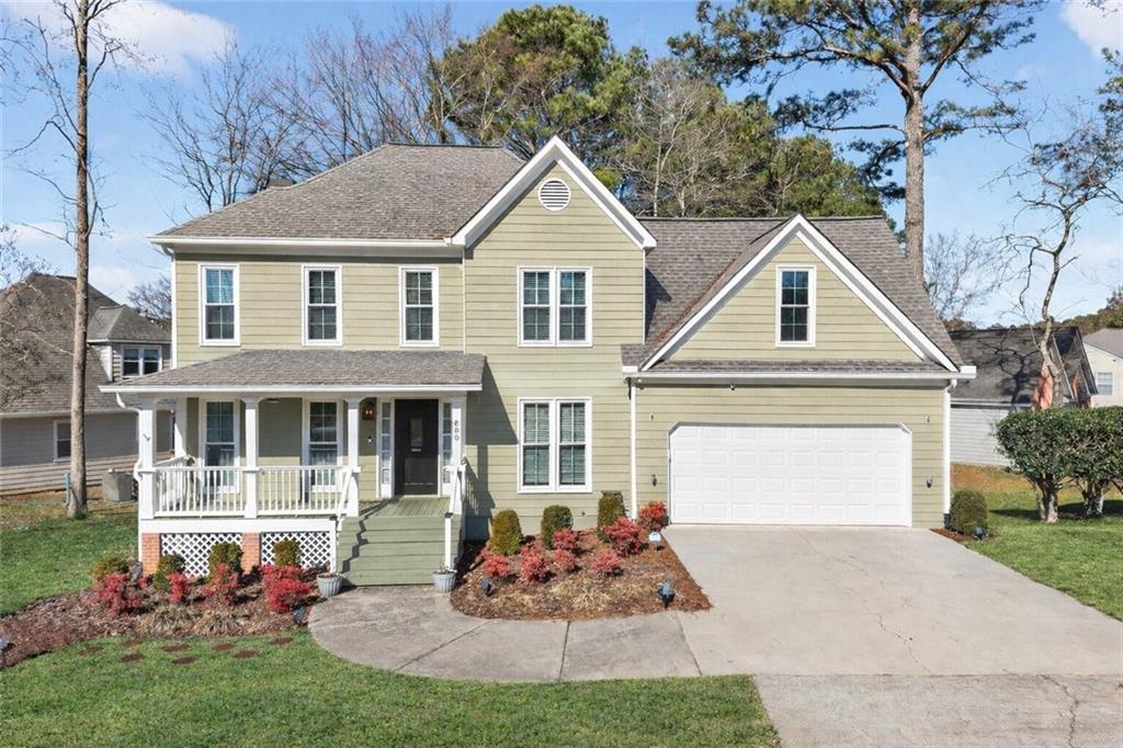 600 Spring Ridge Dr N West Kennesaw, GA 30144 - Photo 1 of 1 a front view of a house with a yard and garage