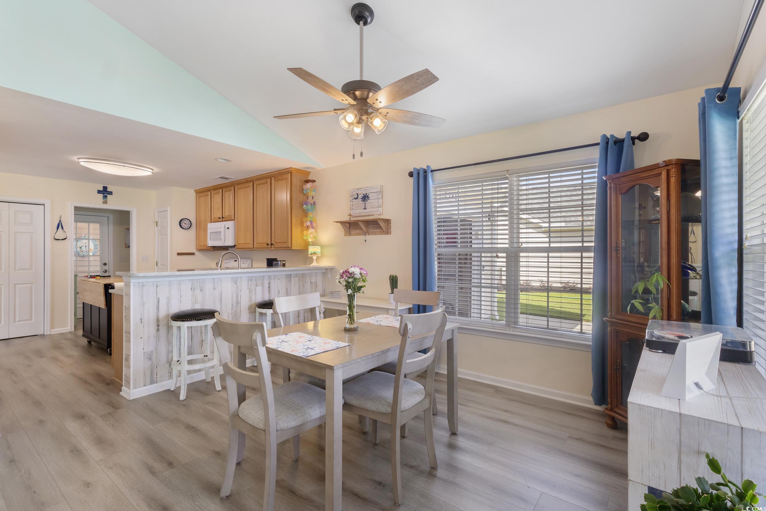 283 Whitchurch Street Murrells Inlet, SC 29576 - Photo 15 of 40 Dining room with lofted ceiling, light wood-type f