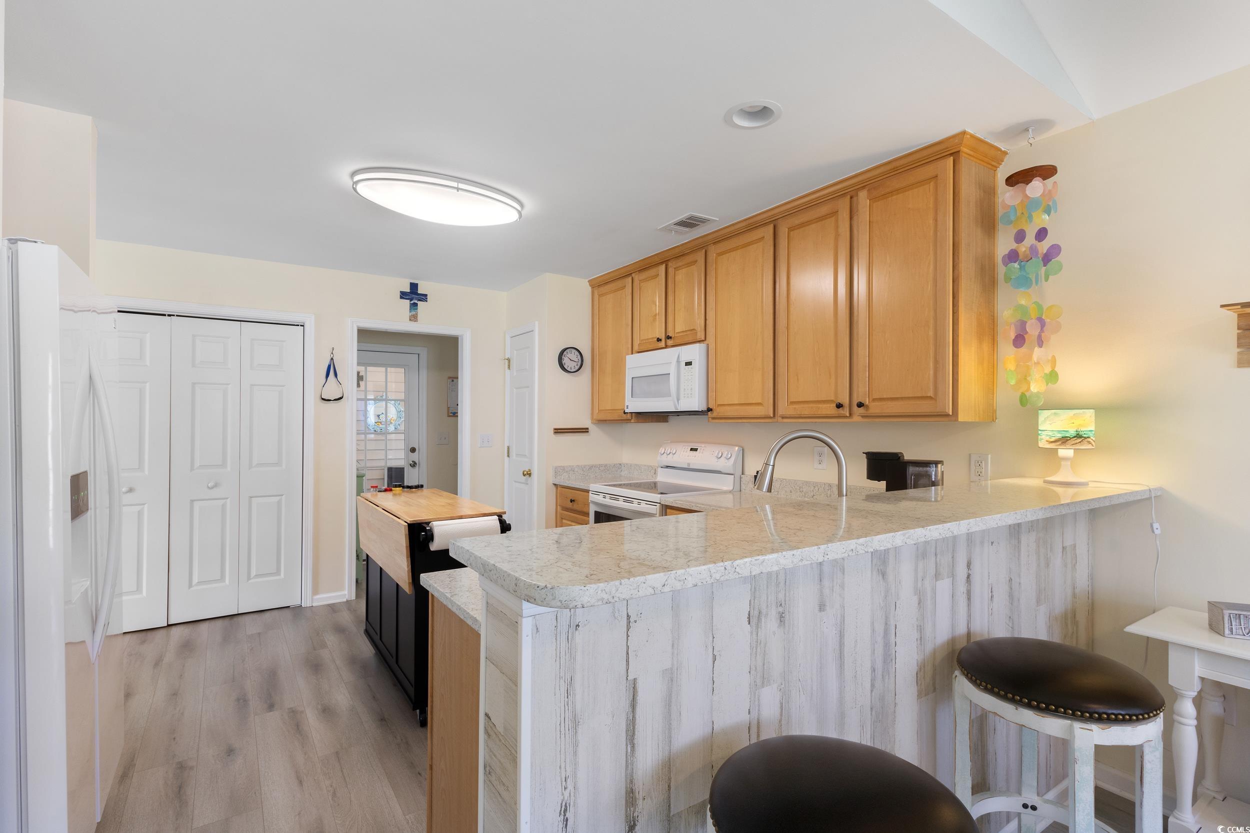 283 Whitchurch Street Murrells Inlet, SC 29576 - Photo 17 of 40 Kitchen featuring white appliances, a peninsula, l