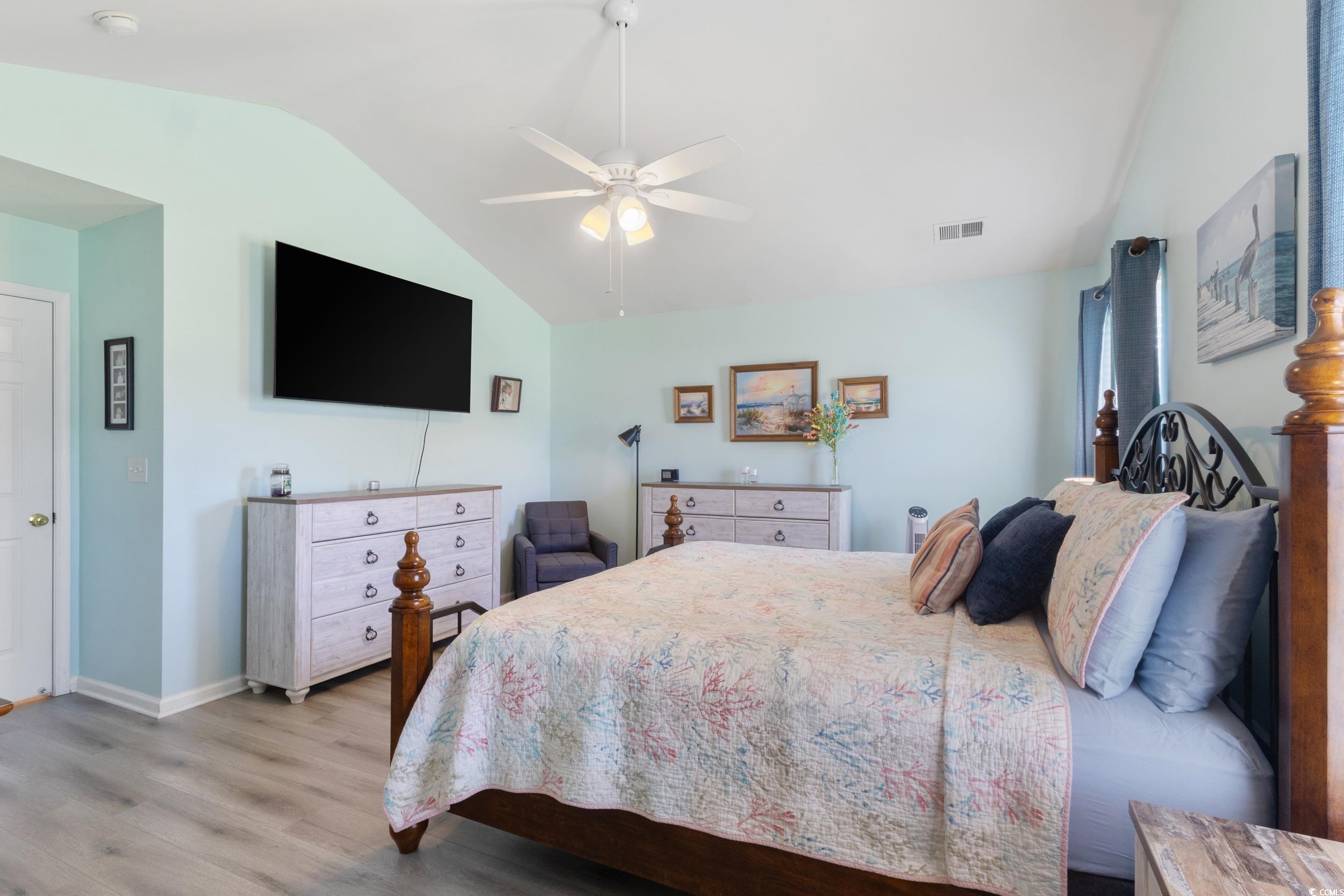 283 Whitchurch Street Murrells Inlet, SC 29576 - Photo 34 of 40 Bedroom with vaulted ceiling, wood finished floors