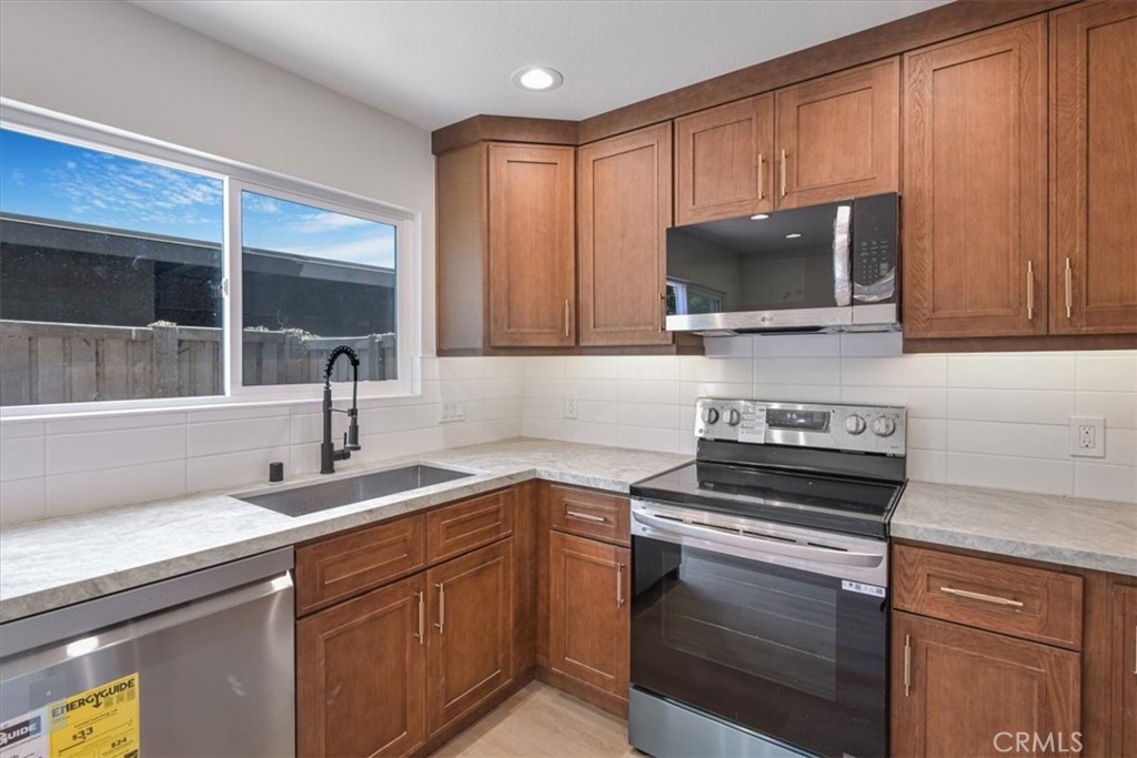 229 Springview Irvine, CA 92620 - Photo 4 of 30 a kitchen with a sink stove and microwave