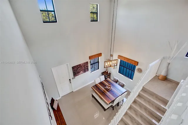 a living room with furniture and a book shelf