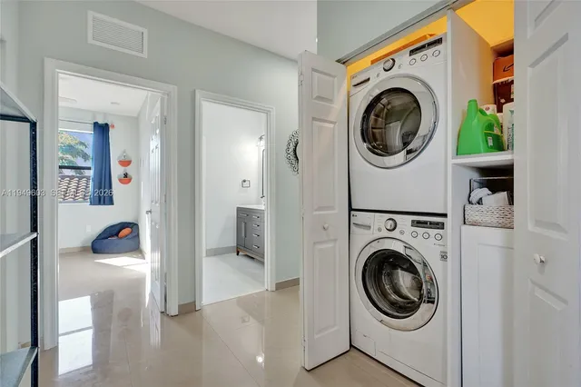 a view of a hallway with washer and dryer