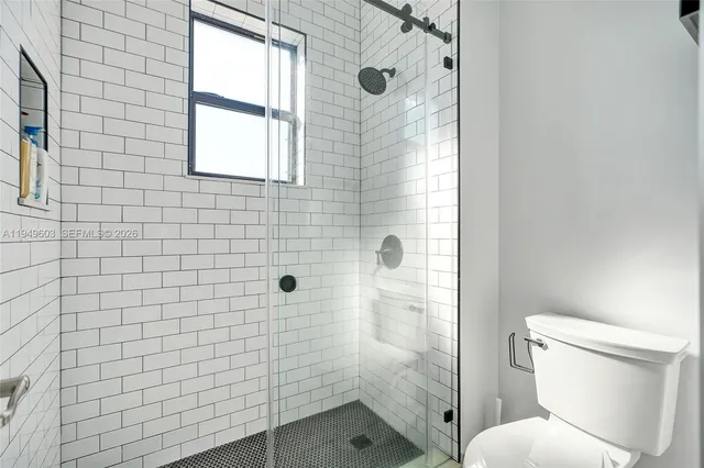 a bathroom with a toilet and a shower