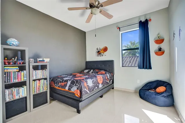 a bedroom with a bed and a book shelf