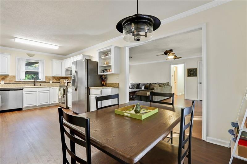 228 Shady Lane Canton, GA 30115 - Photo 11 of 36 a view of a dining room and livingroom with furniture wooden floor a chandelier