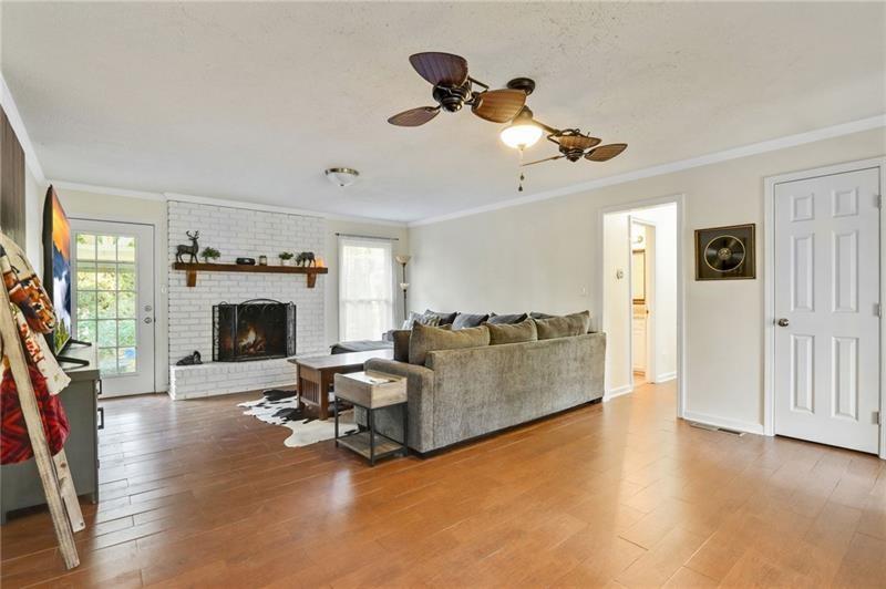 228 Shady Lane Canton, GA 30115 - Photo 2 of 36 a living room with furniture a fireplace and a flat screen tv
