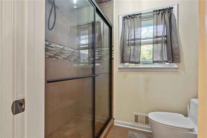 228 Shady Lane Canton, GA 30115 - Photo 27 of 36 a bathroom with a glass shower door