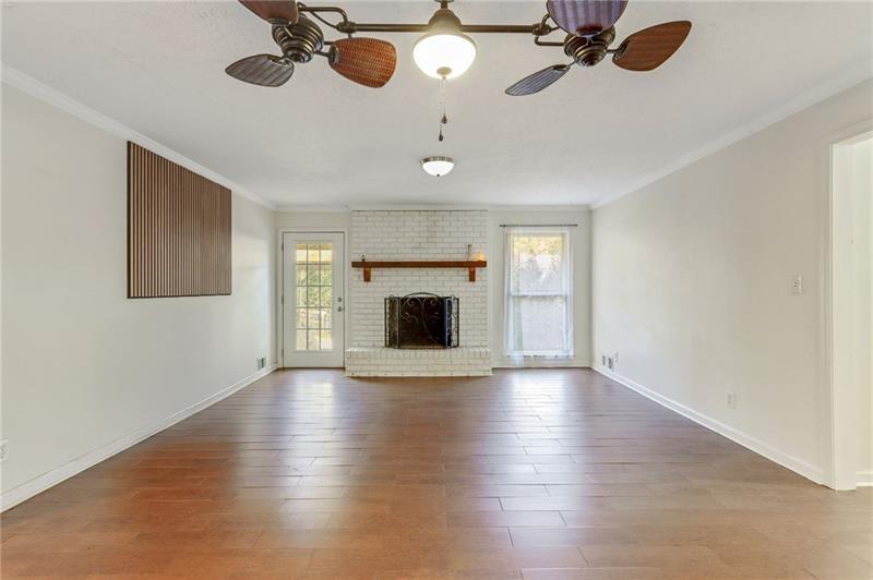 228 Shady Lane Canton, GA 30115 - Photo 3 of 36 a view of an empty room with a fireplace and wooden floor